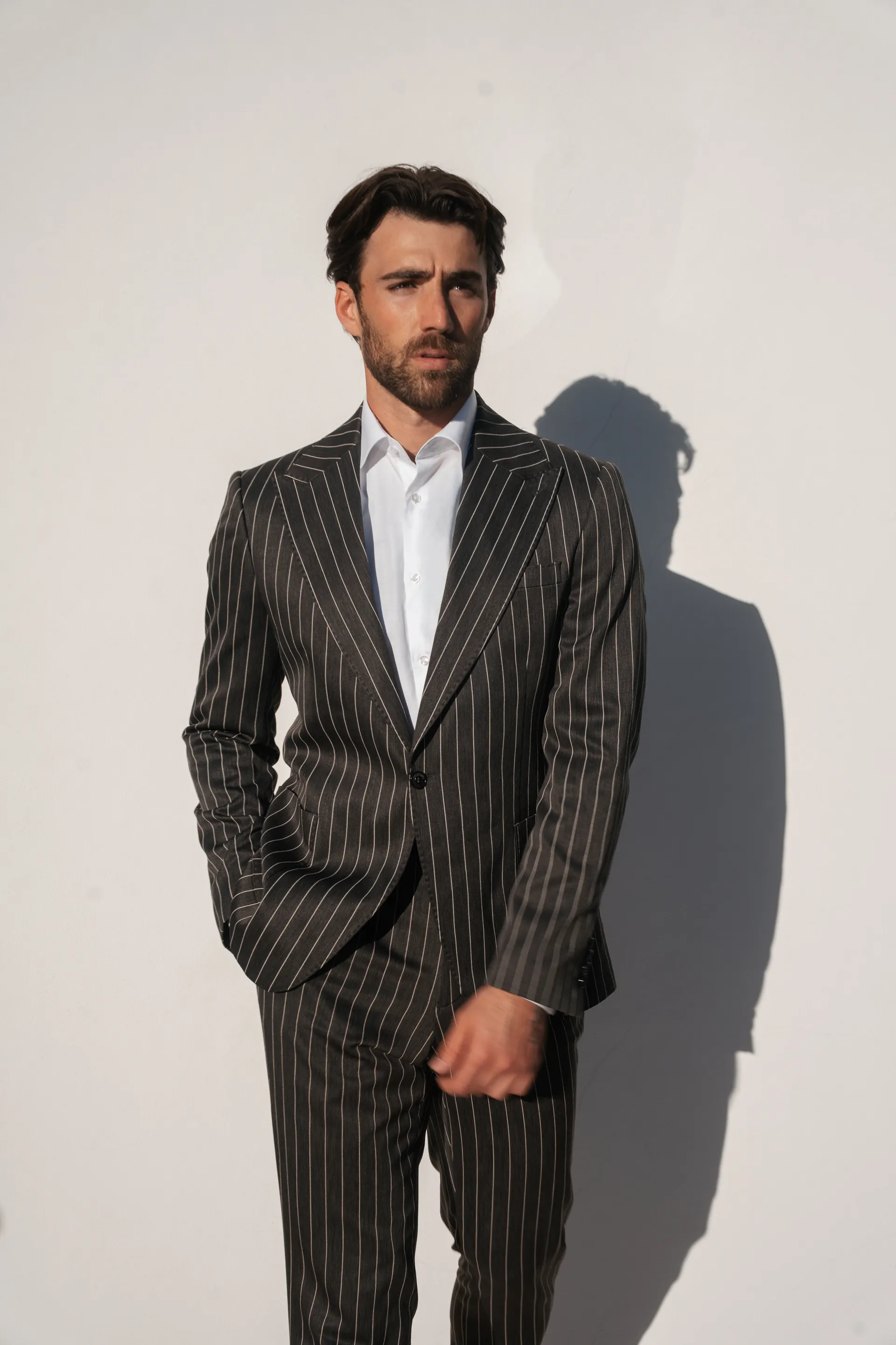 Chalk stripe tailoring against a white wall